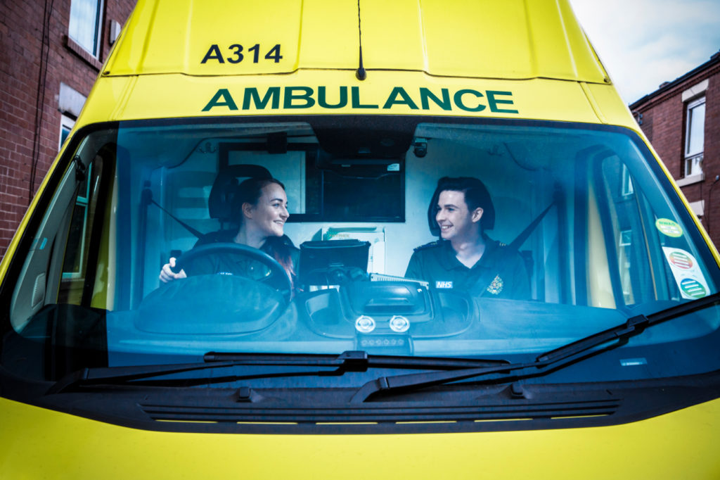 Image of female and male staff inside ambulance