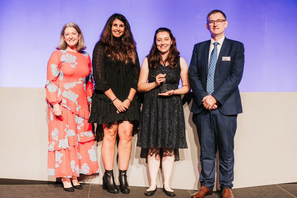 Group of people smiling at award ceremony