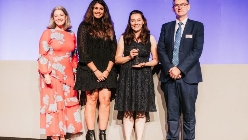 Group of people smiling at award ceremony