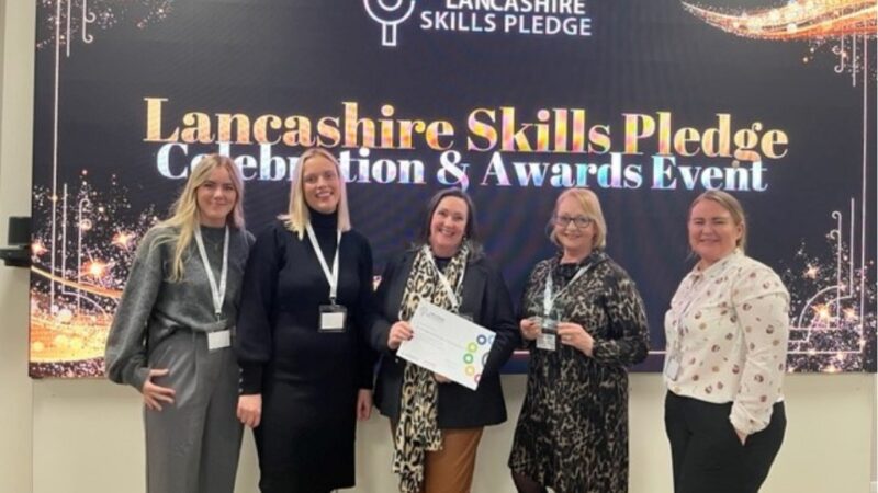 A group of women smiling with a certificate